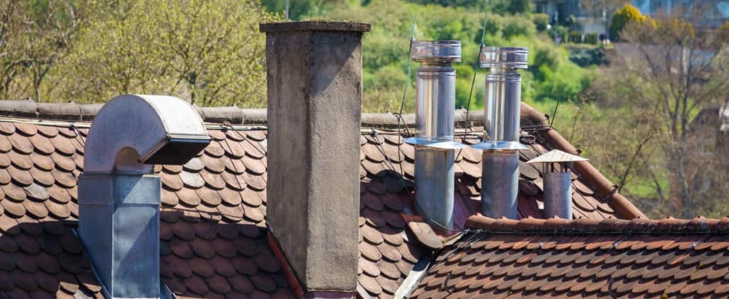 An image of a roof with different chimneys