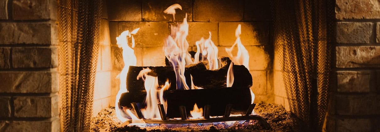 Avoid Chimney Cleaning Logs, logs burning in indoor fireplace