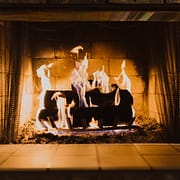 Avoid Chimney Cleaning Logs, logs burning in indoor fireplace