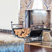 What to Ask a Chimney Professional Before Hiring Them A stack of wood in front of a proper fireplace and chimney serviced by a chimney professional