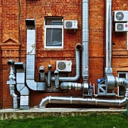 Moving into a New Home? 6 Reasons to Have the Air Ducts Cleaned Several air ducts on a building with new homes who's air ducts need to be cleaned.