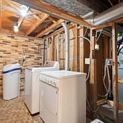 The Importance of a Clean Dryer Vent White washer and dryer in unfinished basement laundry room