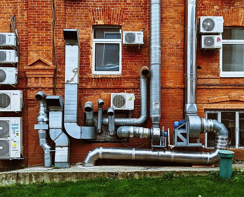 Several air ducts on a building with new homes who's air ducts need to be cleaned.
