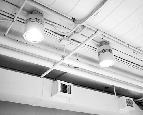 Clean air ducts in a well-lit and clean building hallway