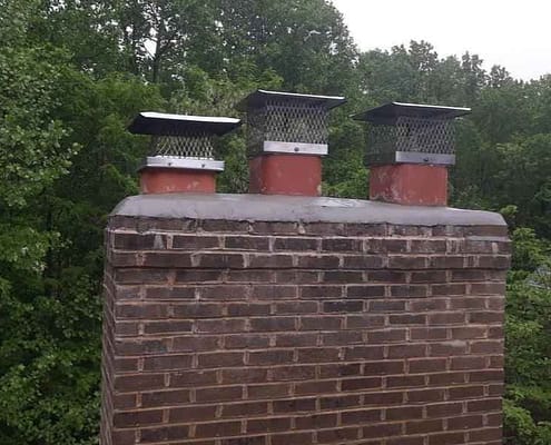 Sixpenny Chimney Sweeps inspecting a damaged chimney crown in Woodbridge, VA