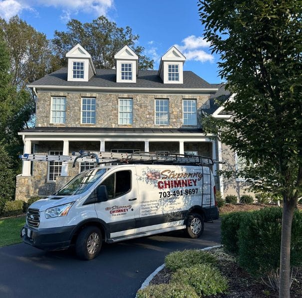 chimney repair near me woodbridge va Chimney repair van parked in front of a stone house in Woodbridge, VA, sturdy and pristine