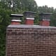 Sixpenny Chimney Sweeps inspecting a damaged chimney crown in Woodbridge, VA