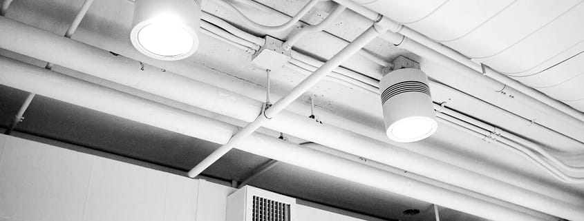 Clean air ducts in a well-lit and clean building hallway