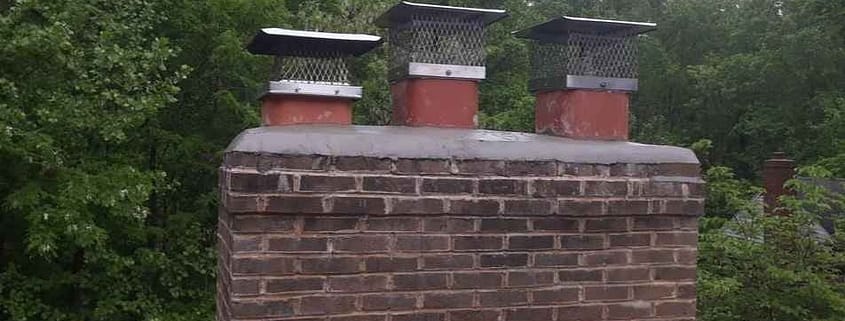 Sixpenny Chimney Sweeps inspecting a damaged chimney crown in Woodbridge, VA