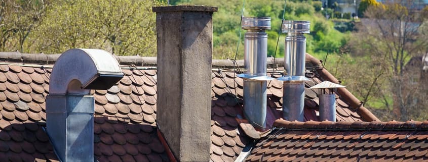 An image of a roof with different chimneys